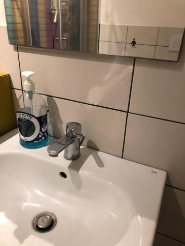 a white sink in a bathroom with a mirror at San Damiano Suite in Catania