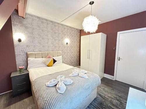 a bedroom with a bed with towels on it at Three Bedroom Near London Eye in London