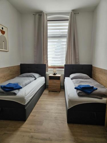 2 camas en una habitación con ventana en Westend 2, en Plauen