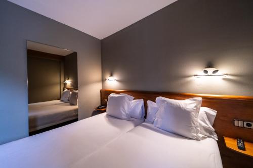 Ένα ή περισσότερα κρεβάτια σε δωμάτιο στο Aparthotel AnyosPark Mountain & Wellness Resort
