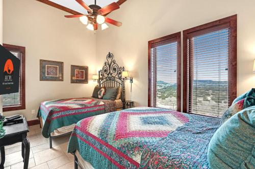 a bedroom with two beds and a ceiling fan at Arc de Texas -Joan of Arc Suite in Johnson City
