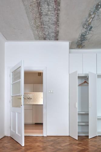 a room with white cabinets and a ceiling at Stará Pekárna/Old Bakery in Znojmo
