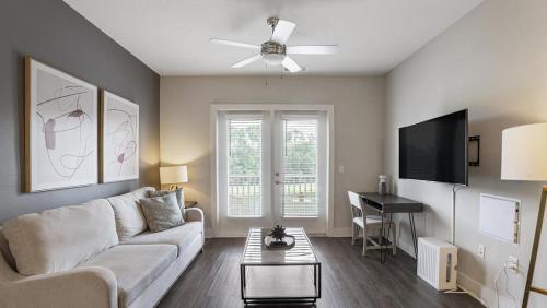 a living room with a couch and a table at Landing at eXchange - 2 Bedrooms in Downtown Detroit in Detroit