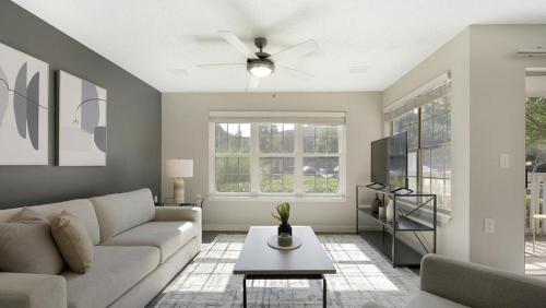 a living room with a couch and a ceiling fan at Landing at Bartram Park - 3 Bedrooms in Southside in Jacksonville