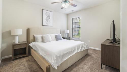 a bedroom with a bed and a flat screen tv at Landing at Crescent Park Commons - 1 Bedroom in Greer in Greer