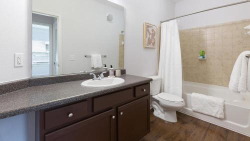 a bathroom with a sink and a toilet and a tub at Landing at The Sovereign at Overland Park Apartments - 1 Bedroom in St. Andrews Highlands in Overland Park