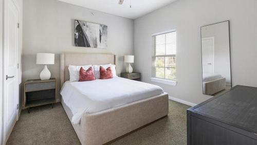 a bedroom with a bed with two night stands and a window at Landing at Mission Hill - 1 Bedroom in New Braunfels in New Braunfels