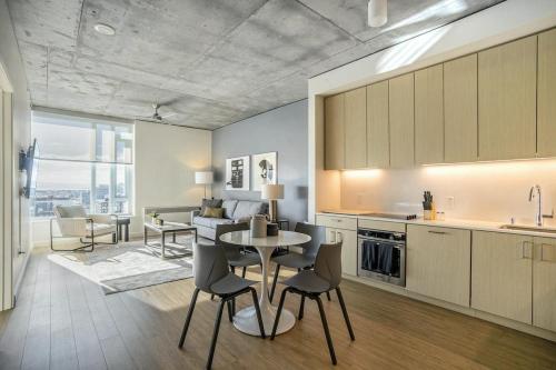 a kitchen and living room with a table and chairs at Landing at Logan Apartments - Studio in Logan Square in Chicago