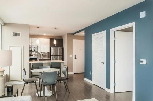 a kitchen and dining room with a table and chairs at Landing at Logan Apartments - Studio in Logan Square in Chicago