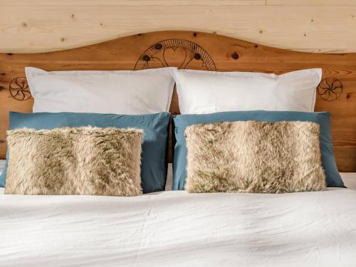 a bed with blue and white pillows at Appartement Villard-de-Lans, 2 pièces, 5 personnes - FR-1-548-43 in Villard-de-Lans