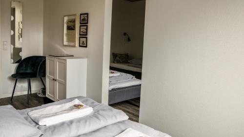 a room with a bedroom with a bed and a desk at B&B by the Sea Hirtshals in Hirtshals