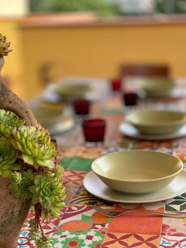 a table topped with plates and bowls on a table at Casa Bella Vista in Gubbio