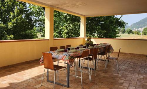 a room with a table and chairs on a patio at Casa Bella Vista in Gubbio