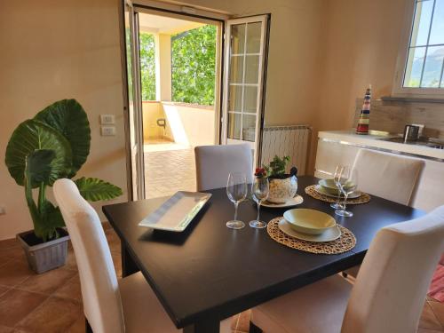 a dining room table with a black table and chairs at Casa Bella Vista in Gubbio