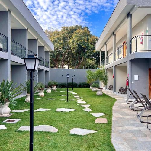 a courtyard of an apartment building with a grass yard at Pousada Piri Paim in Pirenópolis