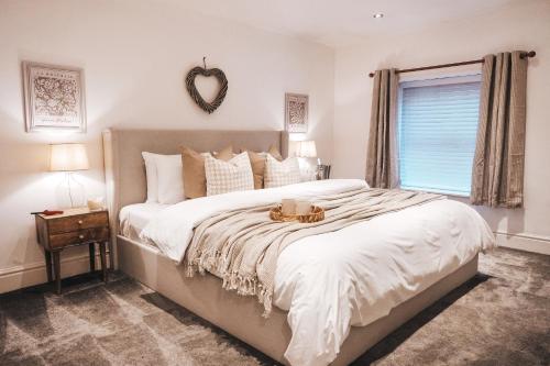 a bedroom with a large bed with a bowl on it at Pye Corner Cottage, by Solace Stays in Bellaghy