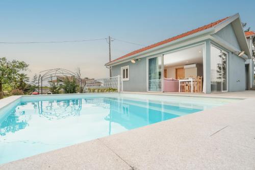 a swimming pool in front of a house at Host Wise - Spacious Comfortable House Pool in Amarante