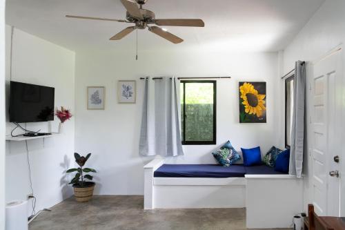 a bedroom with a bed and a ceiling fan at Amara Family 2Br House, pool, 180Mbps, garden , parking Central location in General Luna