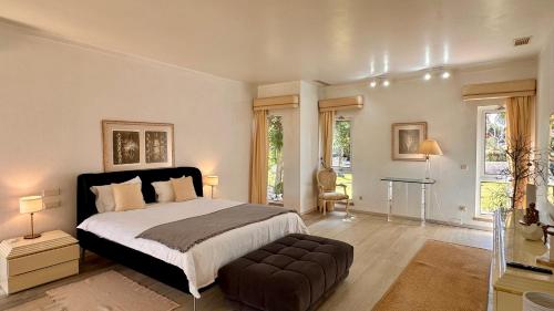 a bedroom with a large bed and a couch at Seventies - Private Pool - 16 Guests - Quarteira in Quarteira