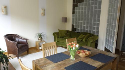 a living room with a table and a green couch at Ferienwohnungen Altstadt in Plau am See