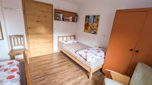 a small bedroom with a bed and a closet at Urlaub wie früher bei Oma in Hermagor