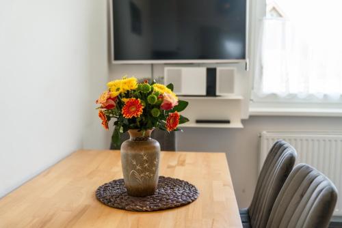 a vase filled with flowers sitting on a table at Easyapartments Leo in Linz