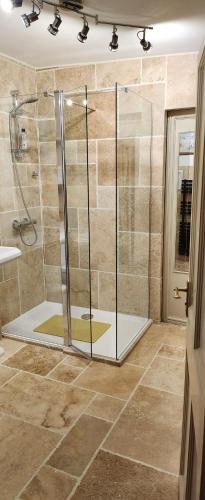 a shower with a glass door in a bathroom at Anzac Street B+Bistro in Dartmouth