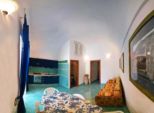 a living room with a table and a kitchen at Casa Acqua Marina 5 in Ponza