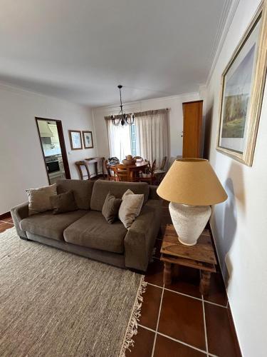 a living room with a couch and a table at Azenhas Apartment in Sintra