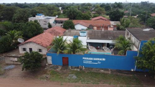 a blue building with palm trees in a city at DICOPI HOTEL in Maringá