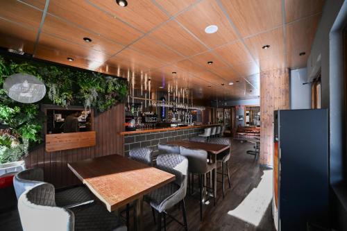 a restaurant with tables and chairs and a bar at Ushuaia, The Mountain Hotel in Arinsal