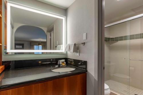 a bathroom with a sink and a mirror at Best Western Plus Executive Suites in Redwood City