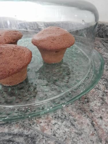 a glass plate with two muffins on top of it at Hotel e Pousada Mape Ltda in Guanamby