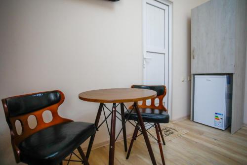 two chairs and a wooden table in a room at city point in Kutaisi