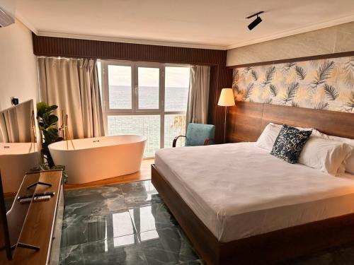 a hotel room with a bed and a bath tub at Villa Marbella by Potenza Rentals in Santo Domingo