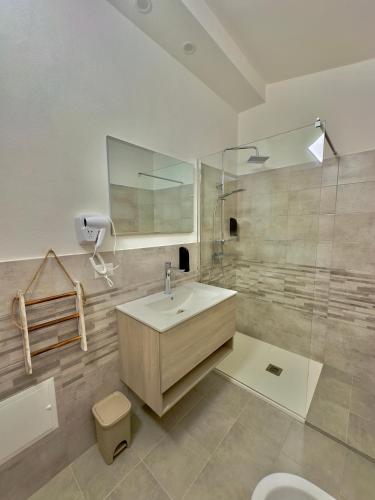 a bathroom with a sink and a shower and a toilet at Casa del Mare in Bosa