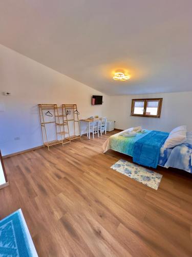 a bedroom with a bed and a table in it at Casa del Mare in Bosa