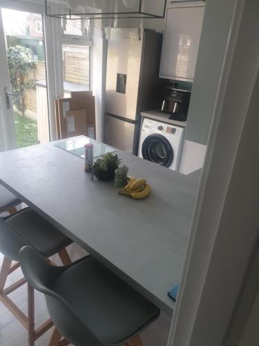 a kitchen with a table with a banana on it at Greys room share in Warrington