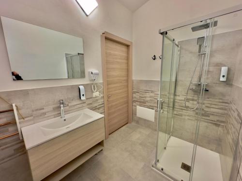 a bathroom with a sink and a shower at Casa del Mare in Bosa