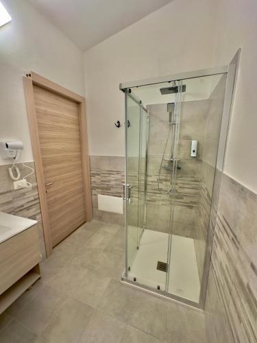 a glass shower in a bathroom with a sink at Casa del Mare in Bosa