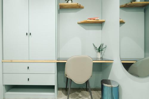 a room with a white chair and a desk at Kashco Apartments Wuse 2 Abuja in Abuja