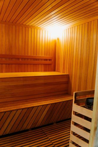 a wooden sauna with a bench in the middle at Green Hill in Almaty