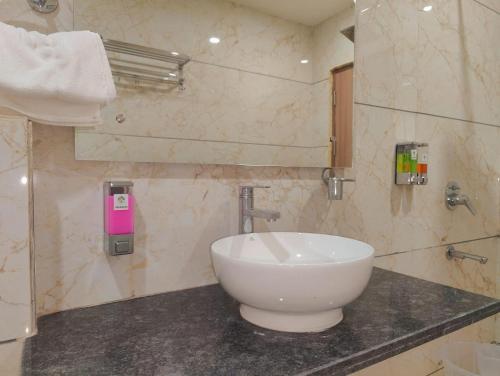 a bathroom with a large white sink on a counter at Hotel Decent -Mahipalpur, Delhi Airport,Aerocity in New Delhi