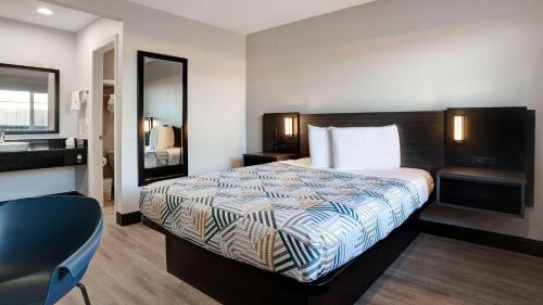 a hotel room with a bed and a mirror at Motel 6-Eureka, CA Redwood Coast in Eureka