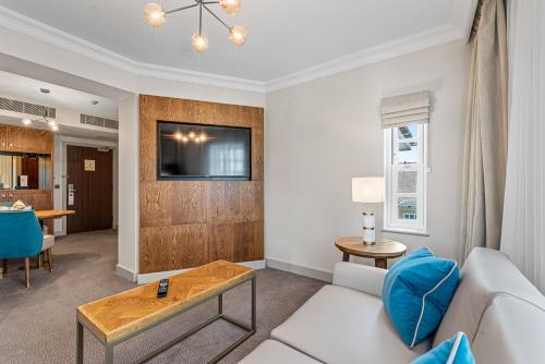 a living room with a white couch and a table at Spa Hotel at Ribby Hall Village in Wrea Green
