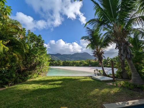 a view of a beach with palm trees at Maison La Plage by Simply-Seychelles in Eden Island