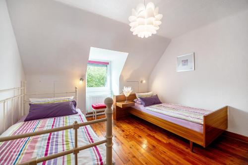 a bedroom with two beds and a chandelier at Domäne Bollinger Morbach in Morbach