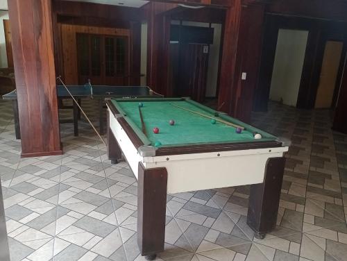 a pool table with balls on top of it at Conora hotel in Itatiaia