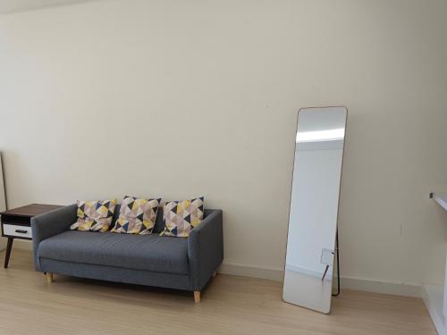 a living room with a couch and a mirror at Infinity homestay @ Champs Elysees kampar in Kampar