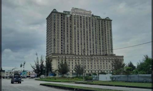 a large building with a sign on top of it at Infinity homestay @ Champs Elysees kampar in Kampar